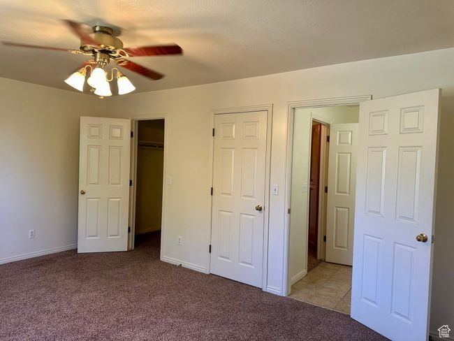 Primary bedroom featuring carpet, a ceiling fan, your own access to the bathroom and a spacious closet | Image 17