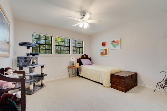 Carpeted bedroom featuring baseboards and ceiling fan | Image 23