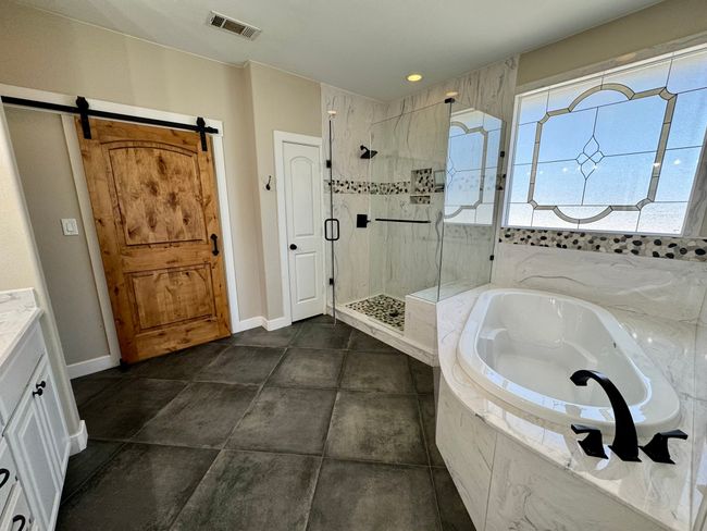 Full bathroom with vanity, baseboards, a stall shower, visible vents, and a bath | Image 14