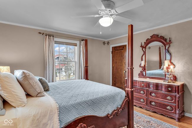bedroom with ceiling fan, light wood-style flooring, and crown molding | Image 19