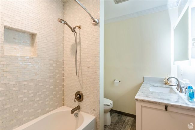 Full bathroom with vanity, tub / shower combination, and wood finished floors | Image 28
