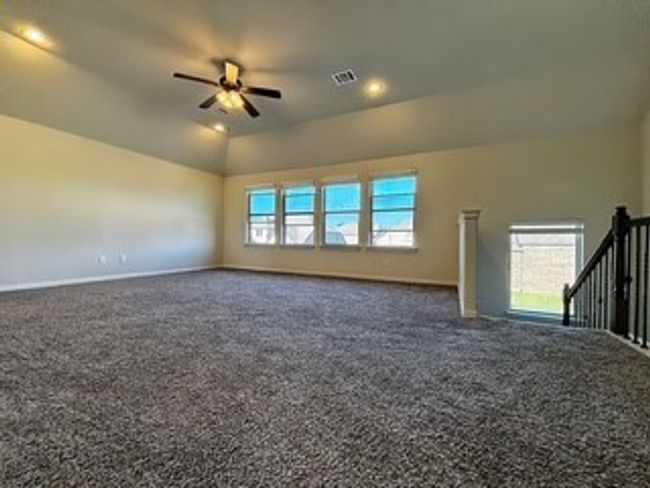 Unfurnished room with dark carpet, a ceiling fan, and recessed lighting | Image 15