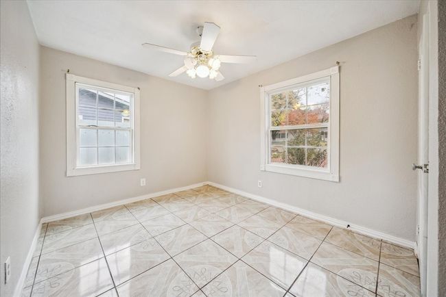 Spare room featuring plenty of natural light and ceiling fan | Image 18