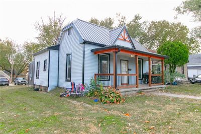 View of front of home featuring covered porch and a front lawn | Image 1