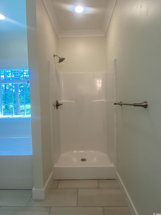 Full bath with a garden tub, crown molding, and tile patterned floors | Image 28