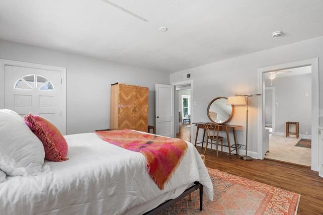 Bedroom showing separate entrance and hallway/kitchen entryways. | Image 13