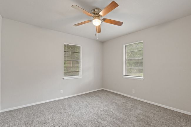Carpeted empty room featuring ceiling fan and baseboards | Image 17