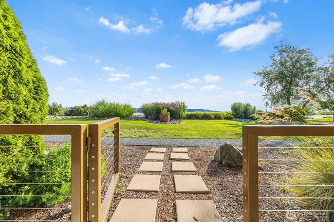 Gate out to grounds from covered patio space. | Image 27