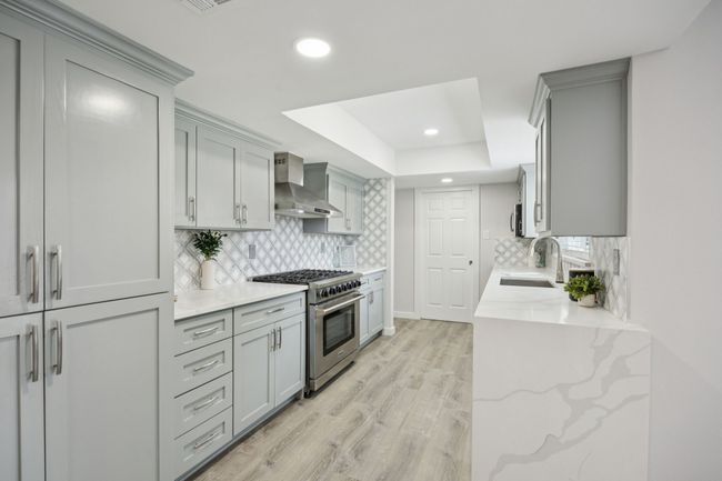 This kitchen looks as if it is straight out of a magazine! NEW Cabinets, Quartz Counter Tops, Undermount Sink and Faucet - soft closing doors and drawers! | Image 14