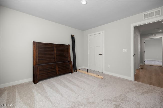 bedroom featuring baseboards, visible vents, and carpet floors | Image 12