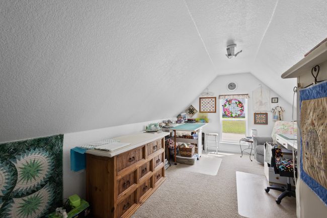 Carpeted office featuring a textured ceiling and vaulted ceiling | Image 28