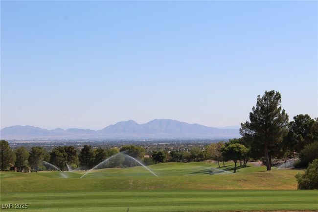 View of property's community featuring a yard, a mountain view, and view of golf course | Image 24