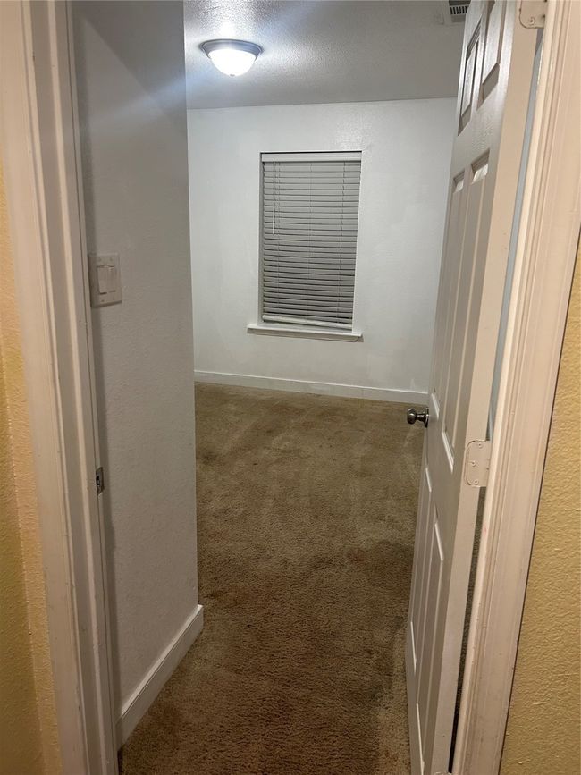 Corridor featuring carpet flooring and a textured ceiling | Image 9