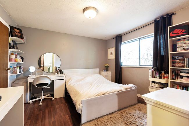 Bedroom featuring wood finished floors and a textured ceiling | Image 20