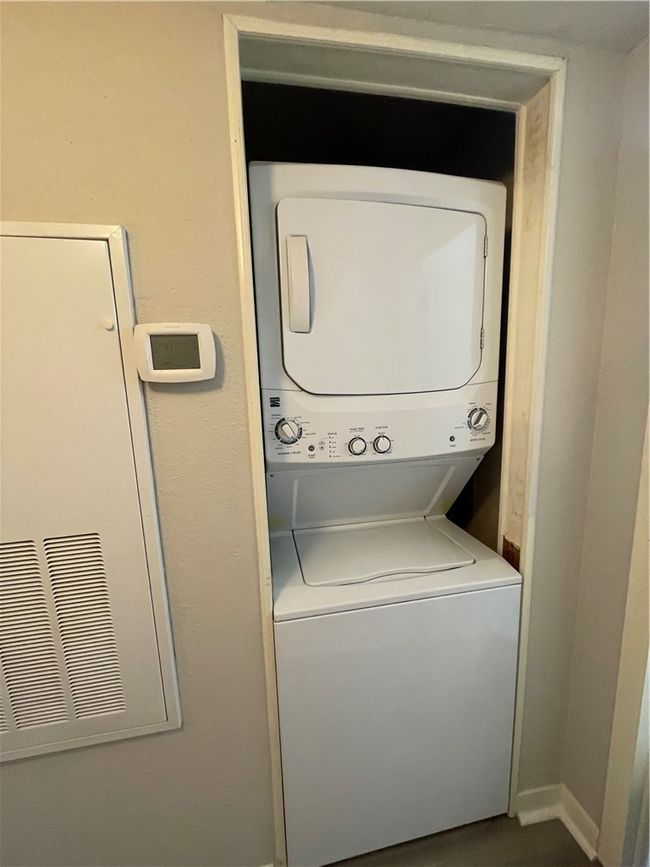 Washroom featuring stacked washer / drying machine | Image 14