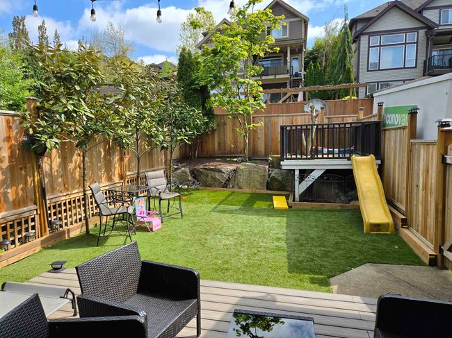 View of yard featuring a wooden deck and a fenced backyard | Image 31