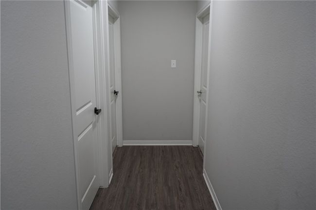 Hall featuring dark wood-type flooring and baseboards | Image 9