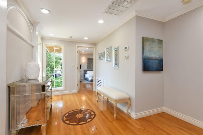 Hallway with light wood finished floors, baseboards, visible vents, and recessed lighting | Image 10