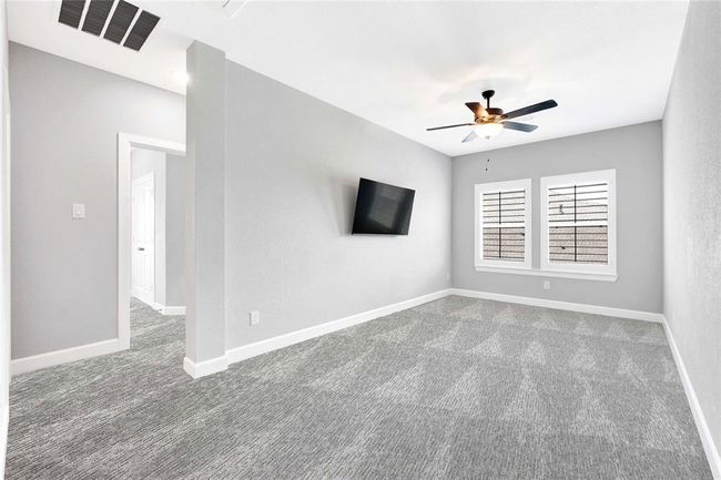 Flex space upstairs in the center of three secondary bedrooms. Plantation shutters, upgraded plush carpet, ceiling fan complete the room | Image 37