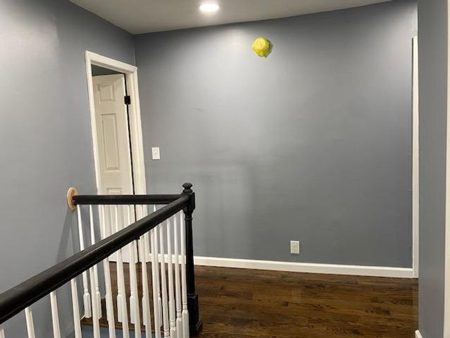 Staircase with wood finished floors and baseboards | Image 22