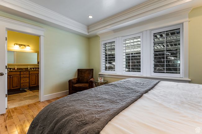 Bedroom featuring recessed lighting, light wood-type flooring, ornamental molding, baseboards, and connected bathroom | Image 11