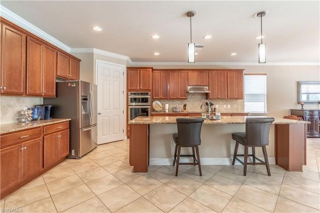 Kitchen featuring dishwasher, a kitchen island with sink, sink, and ceiling fan | Image 12