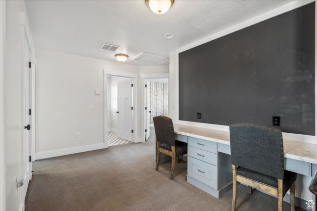Office space featuring built in study area, carpet flooring, visible vents, and baseboards | Image 33