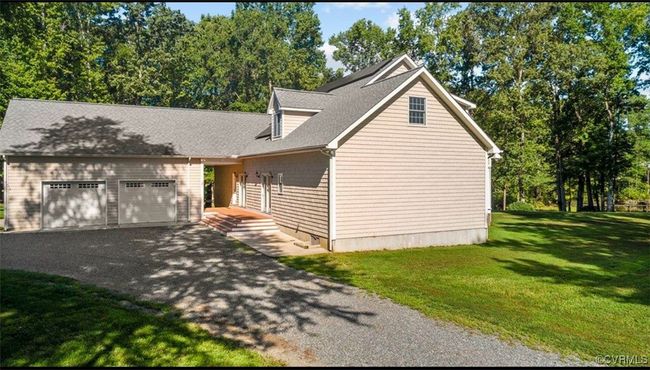 View of front of house featuring a front yard, asphalt driveway, a shingled roof, and an attached garage | Image 5
