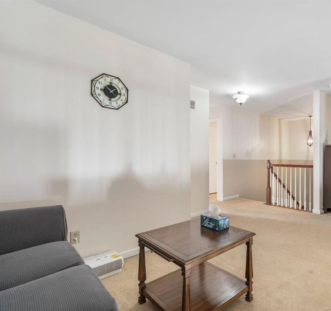 Bedroom with light colored carpet and vaulted ceiling | Image 10