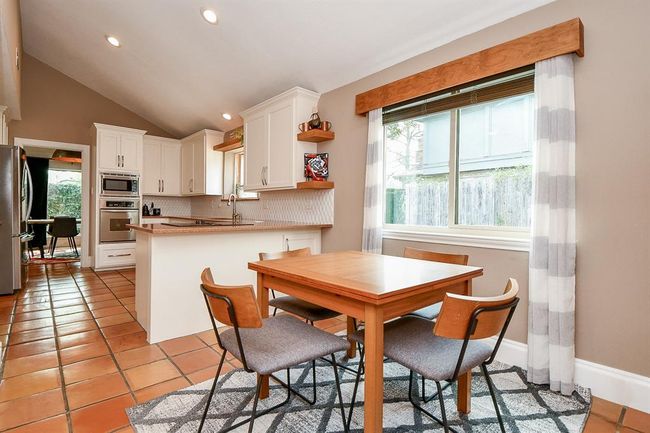 The streamlined theme in your kitchen features great natural light (especially for a breakfast nook, as suggested here), desert toned tile flooring and counters and creamy white cabinetry. | Image 17
