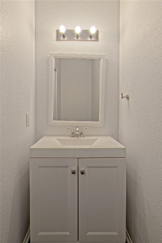 Bathroom with vanity and a textured wall | Image 16