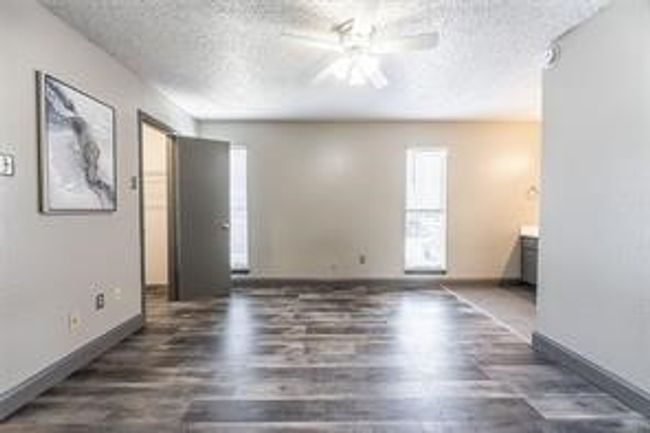 Unfurnished living room featuring a ceiling fan, a textured ceiling, and wood finished floors | Image 8
