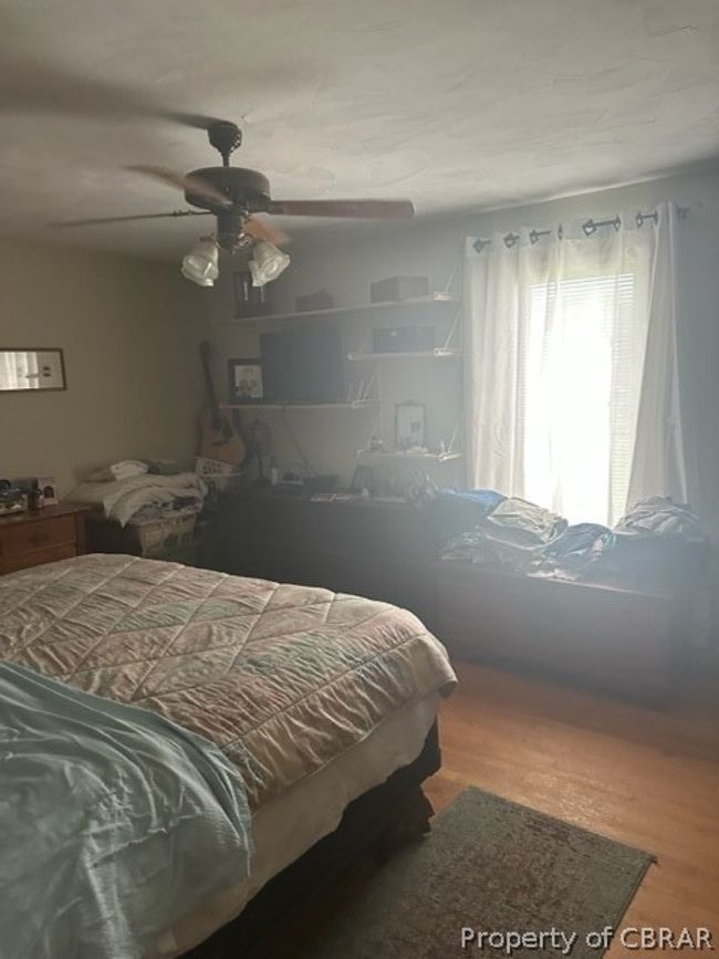 Bedroom with ceiling fan and hardwood / wood-style floors | Image 15