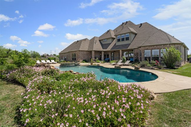 View of pool featuring a patio area and a pool with connected hot tub | Image 5