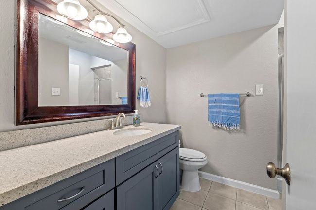 The secondary bath features a large vanity and offers dual access from the common area and second bedroom. | Image 23