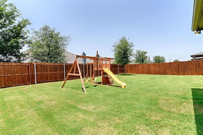 Fenced backyard with a playground | Image 6