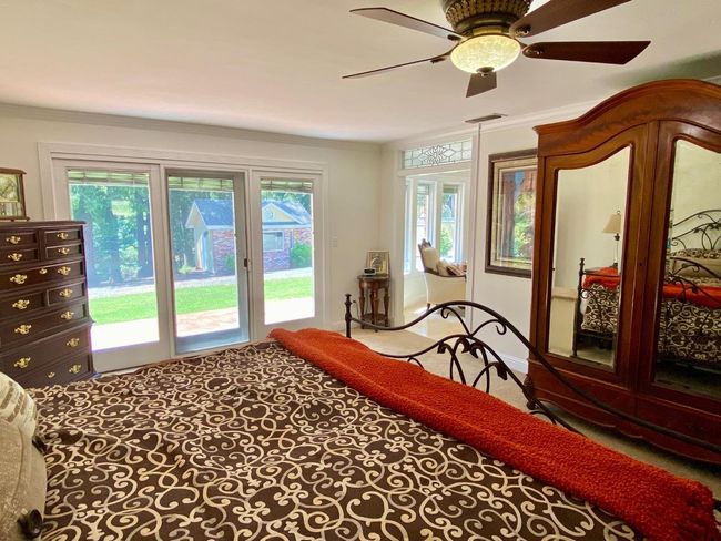 Wonderful windows and glass door to back, wide entry with stained glass transom above into Master bath. | Image 46