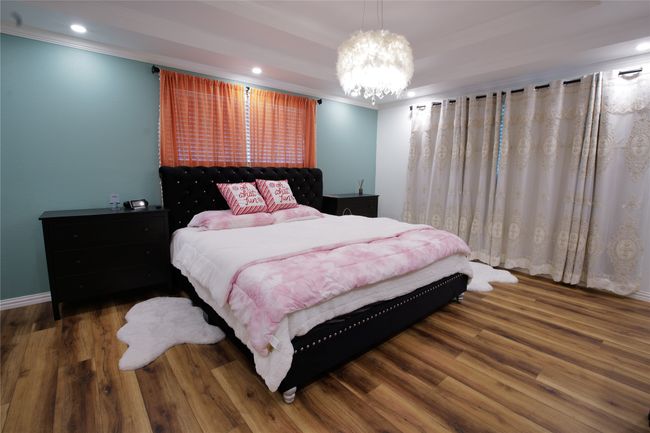Bedroom featuring crown molding, wood finished floors, a chandelier, and recessed lighting | Image 16