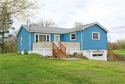 View of front of property featuring a front lawn and a garage | Image 1