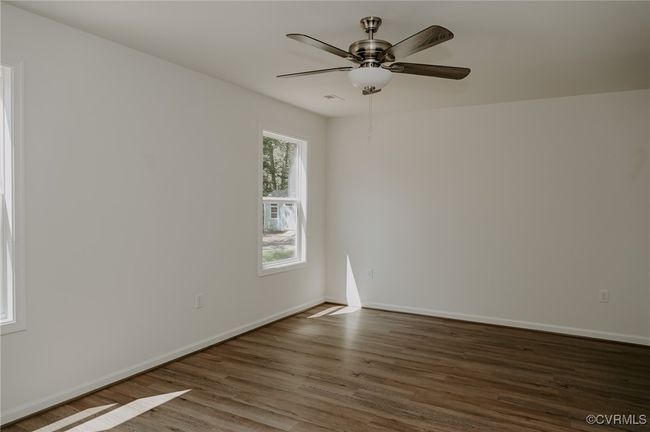 Unfurnished room with ceiling fan and dark hardwood / wood-style flooring | Image 11