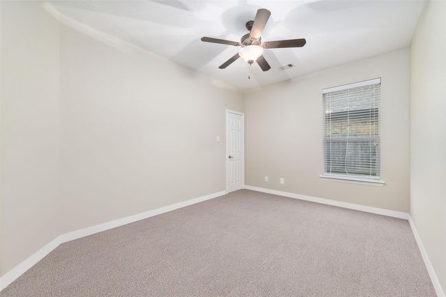 Secondary bedroom #2 at the front of the home. Has been virtually altered to remove boxes. | Image 11