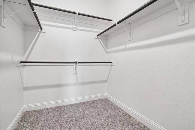 Walk in closet featuring light carpet | Image 17
