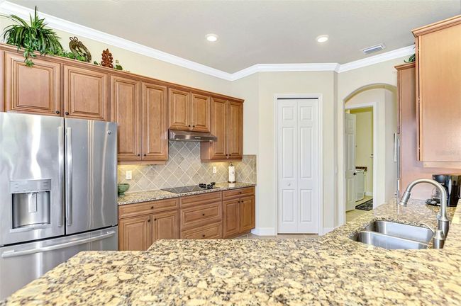 Honey-Glazed Maple Cabinetry, Stainless and Granite Counters | Image 23