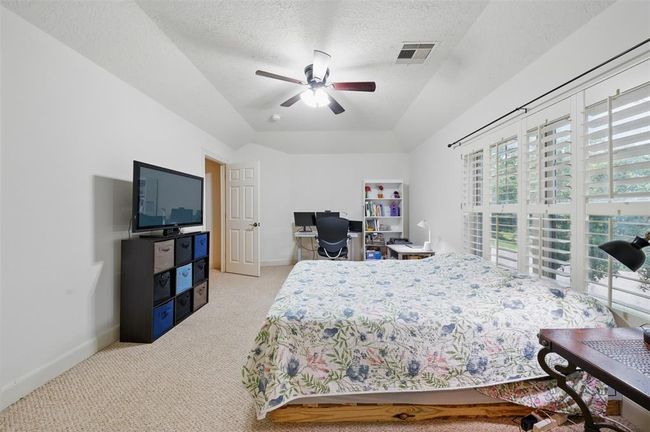 Another spacious upstairs bedroom on the front of the home with vaulted ceilings and en-suite bath. | Image 36
