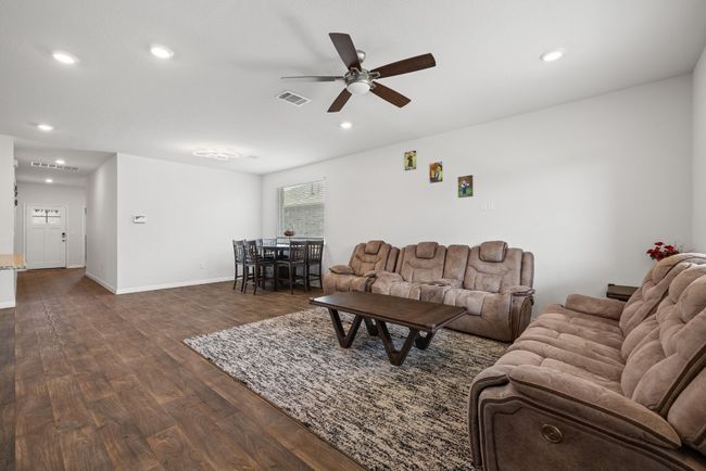 Living area featuring ceiling fan, dark wood-style flooring, recessed lighting, and baseboards | Image 8