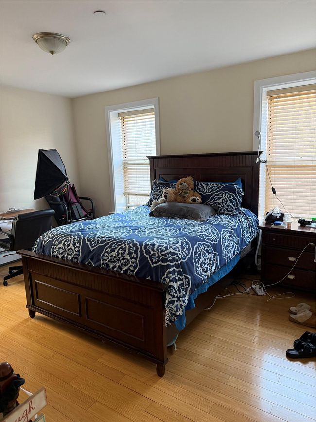 Bedroom with light wood-style flooring | Image 6