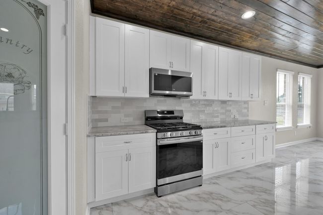 Kitchen and breakfast area on the right. | Image 16