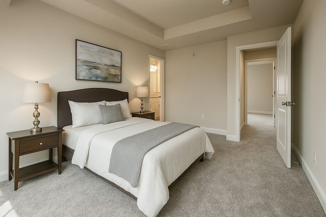 Bedroom featuring a tray ceiling, baseboards, and light colored carpet | Image 18