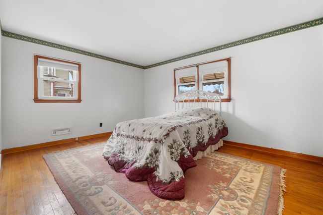 Bedroom with hardwood / wood-style floors, multiple windows, and baseboards | Image 23