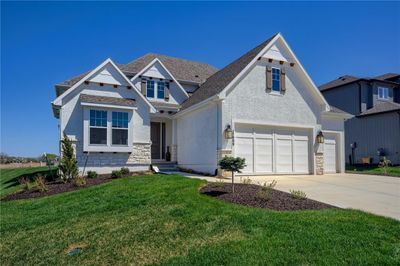 View of front of property with a garage and a front yard | Image 2